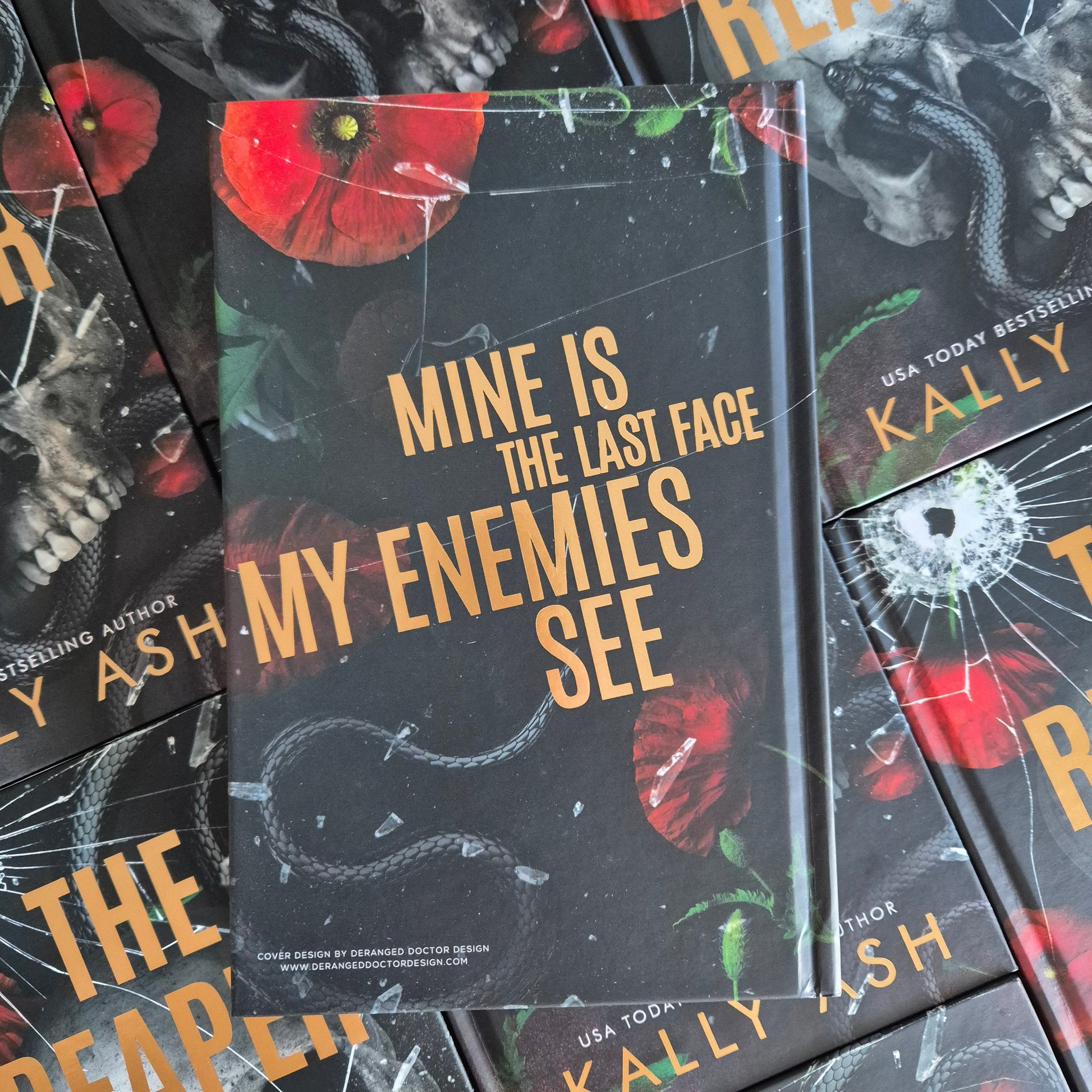 Stack of books with a dark cover featuring text and images, including poppies and a snake.